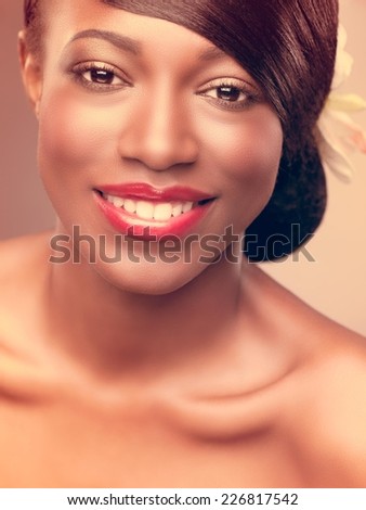 Beautiful african woman with healthy silky hair smiling.