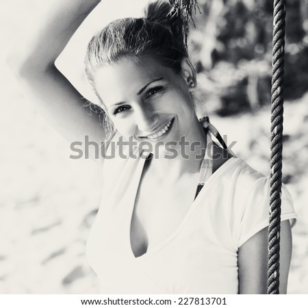 Young woman enjoying summer breeze at the beach. Black and white.