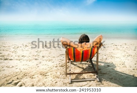 Man enjoying lazy afternoon at the beach.