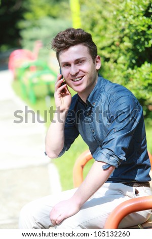 Russian red hair man in park with telephone