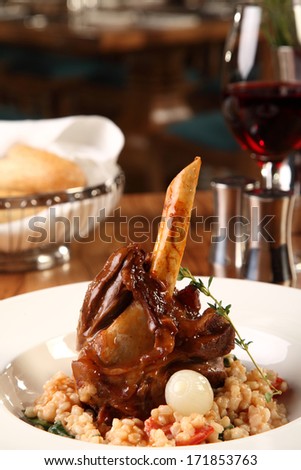 Restaurant table with lamb shank served