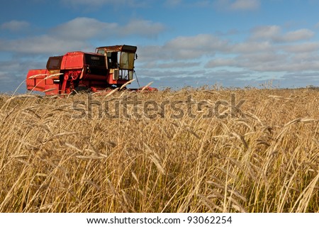 Aging Combine Harvester in field, Paibeil, North Uist, Scotland. October 2011