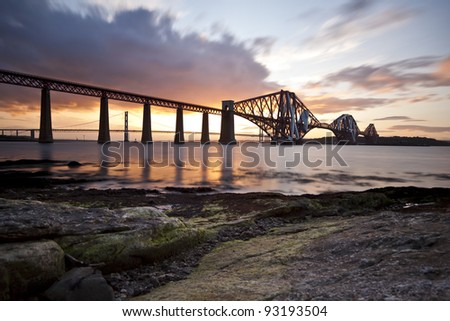 Forth bridges at sunset. The Forth Bridge is a cantilever railway bridge near Edinburgh, Scotland. It was opened in March 1890. It was the first major structure in Britain to be constructed of steel.