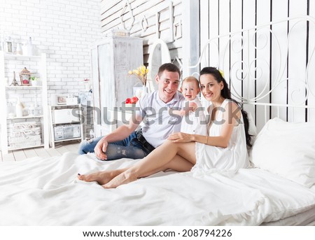 Good morning! Lovely family sitting together on the bed