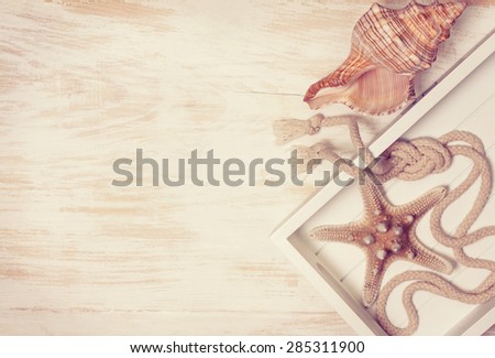 Starfish and rope on a wooden background (sea decoration)