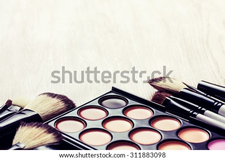 Professional makeup palette, makeup brushes, makeup products  with copyspace (Toning, instagram filter)