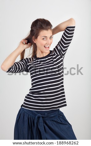 young girl in a striped blouse on a gray background