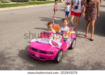 AUSTIN, TX - JULY 4, 2014 - Fourth of July Parade participants march down the streets of the Mueller neighborhood in Austin, TX on July 4, 2014