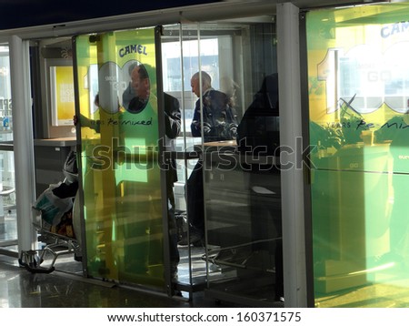 FRANKFURT, GERMANY - MAR 10 - Smokers at the airport are isolated to protect the health of other passengers and workers on Mar 10, 2013 in Frankfurt, Germany