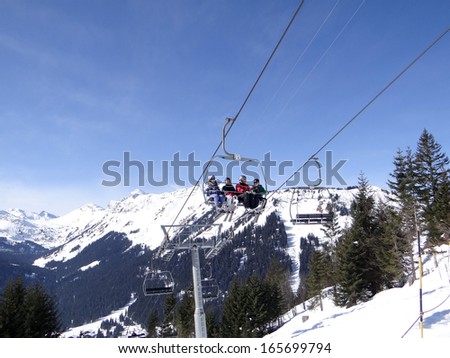 CHATEL, FRANCE - MAR 1 - Ski lift carries holiday skiers up the mountain  to the ski slopes above Chatel on Mar 1, 2013 in France.