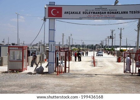 AKCAKALE, TURKEY - Jun 8, 2014 - People enter the Akcakale Syrian  refugee camp near the Syrian border,  in Southeastern Turkey, June 2014