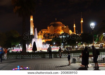 ISTANBUL, TURKEY - MAY 15, 2014 -Late night walkers view the lighted Hagia Sophia  in Istanbul, Turkey