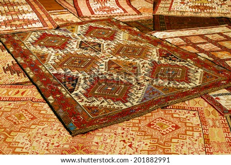 Overlapping carpets with intricate Kurdish  patterns in rug store  in Istanbul, Turkey