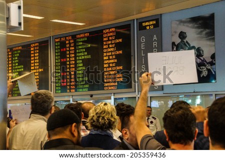 ISTANBUL, TURKEY - MAY 15, 2014 -Arriving passengers run the gauntlet of travel guides as they exit customs area of the airport  in Istanbul, Turkey