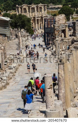 EPHESUS, TURKEY - MAY 25, 2014 - Tourists walk down the main street towards the Library of Celsus  Ephesus, Turkey