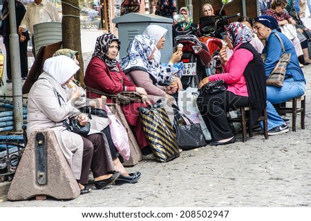 BURSA, TURKEY - MAY 22, 2014 - Women with scarves take a break  in the bazaar of  Bursa, Turkey