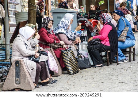BURSA, TURKEY - MAY 22, 2014 - Women with scarves take a break  in the bazaar of  Bursa, Turkey