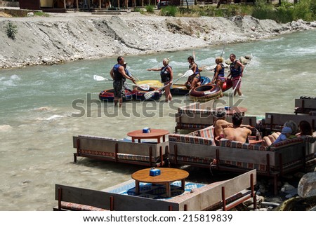 SAKLIKENT, TURKEY - MAY 31, 2014 - Tourists relax on platforms built over the whitewater river  near Saklikent gorge,  Turkey