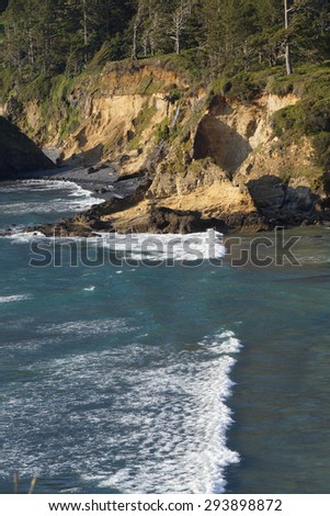 Beach and surf near rocky coast hillsides,  Oregon Coast