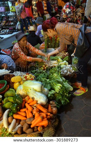SIEM REAP, CAMBODIA - FEB 16, 2015 - Woman selling vegetables in the market of  Siem Reap,  Cambodia