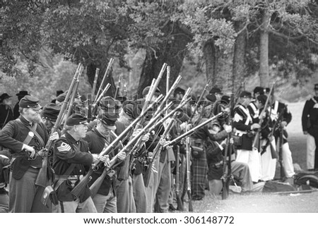 PORT GAMBLE, WA - JUN 20, 2009  - Civil War reenactors participate in a mock battle on Jun 20, 2009. Union infantry line firing a volley,  Civil War Battle Re-enactment,  Port Gamble, WA