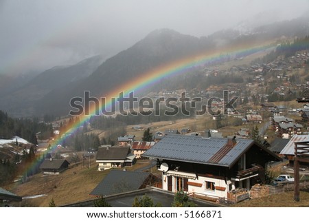 Rainbow across alpine village,		Chatel,French Alps,	France