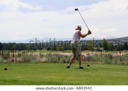 Lady golfer hitting ball from tee,		Eagle Crest Resort Golf Course,	Central Oregon