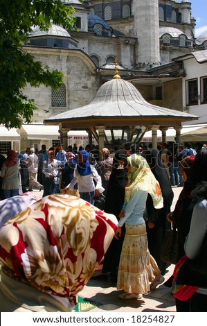 ISTANBUL TURKEY - JUNE 2006: Veiled women in mosque courtyard,	Eyup Mosque,	Istanbul	Turkey