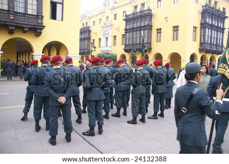 LIMA, PERU - AUGUST 30: Female police officers  in red berets watch a parade in Lima, Peru on August 30, 2008.