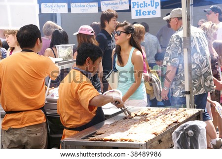 SEATTLE, WA – MAY 17 :  Asian cooks serve food at concessions  at a street fair on May 17, 2009  in Seattle, WA.