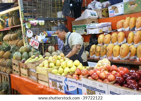 MEXICO CITY - SEPTEMBER 3 : Fruit stall vendor tends his produce in the Merced Market on September 4, 2008 in Mexico City.