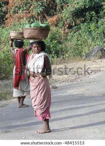 ORISSA INDIA - NOV 11 - Women carry goods on their heads for  weekly market  in Orissa, India