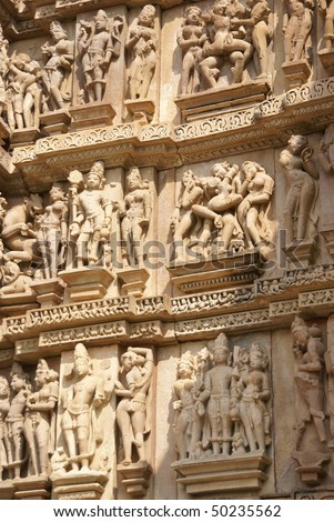 Sculptures of loving couples, maithuna, mythical figures on outer walls of  Visvanatha Temple at  Khajuraho,  India