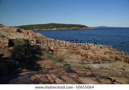 Calm ocean and shoreline of  granite ledges,  Schoodic Point, Acadia National park, Maine, New England