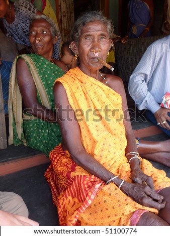 ORISSA,  INDIA - NOV 10  - Old woman smokes a cheroot in a tribal village  on Nov 10, 2009 in Orissa, India