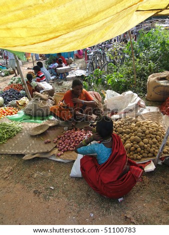 ORISSA, INDIA - NOV 11 - Woman selling potatoes  on Nov 11, 2009,  in Chatikona market, Orissa, India