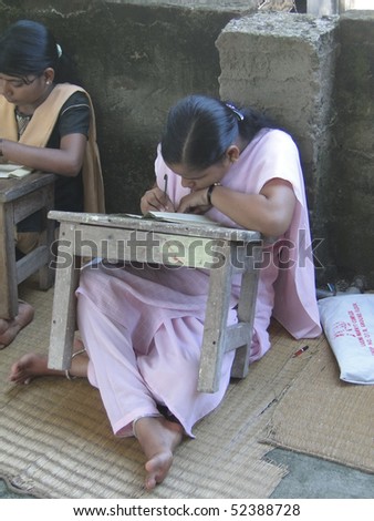 PURI, INDIA - NOV 15 -  Student practises engraved calligraphy on palm leaves   on Nov 15, 2009  in Puri, India