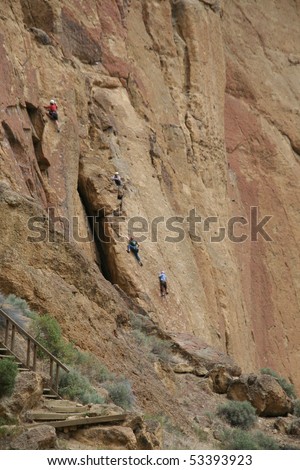 Rock climbers and belayers on sheer cliff,Smith Rock State Park, Central Oregon