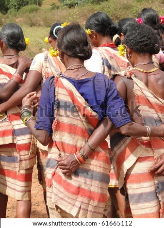 Village women link arms for Gdaba harvest dance in Lamptaput, Orissa, India