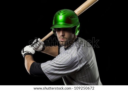 Baseball Player ready to swing, on a green uniform.