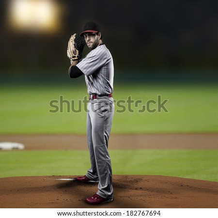 Pitcher  Player throwing a ball, on a baseball Stadium.