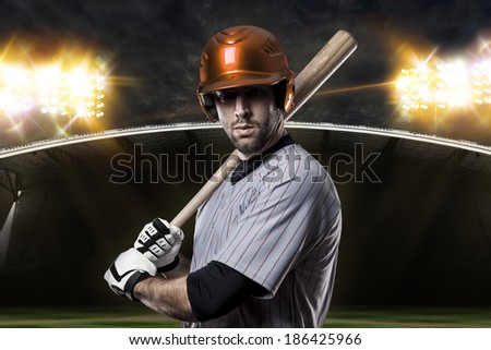 Baseball Player on a Orange Uniform on baseball Stadium.