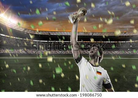 German soccer player, celebrating the championship with a trophy in his hand.