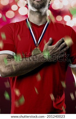 Swiss soccer player, listening to the national anthem with his hand on his chest. On a red lights background.