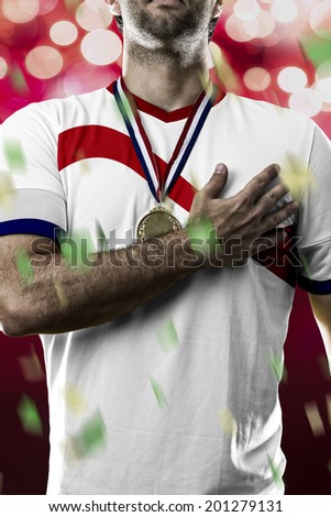 costa rican soccer player, listening to the national anthem with his hand on his chest. On a red lights background.