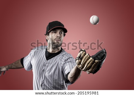 Baseball Player on a Red Uniform on red background.