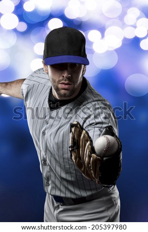 Baseball Player on a Blue Uniform on blue lights background.