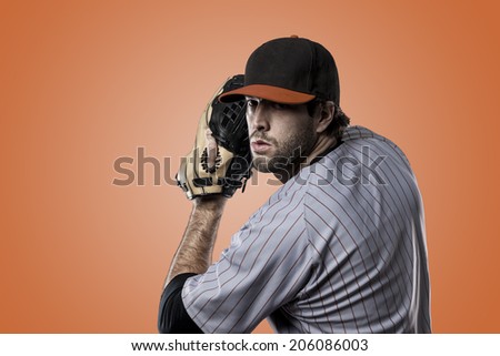 Baseball Player on a orange Uniform on orange background.