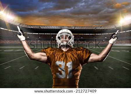 Football Player on a Orange uniform celebrating on a stadium background.