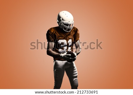 Football Player on a Orange uniform, on a orange background.